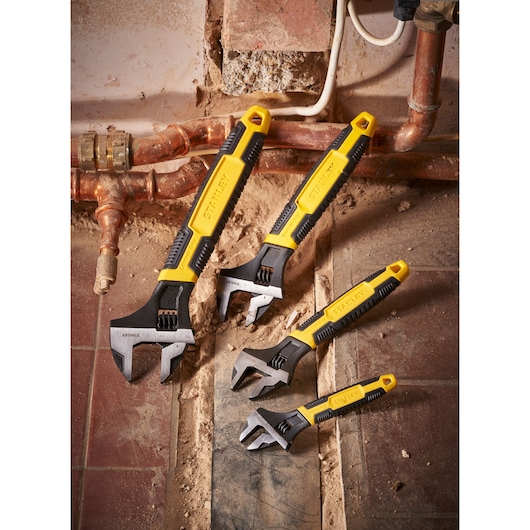 STANLEY 0-90-947 adjustable wrenches set with yellow and black handles on construction site.