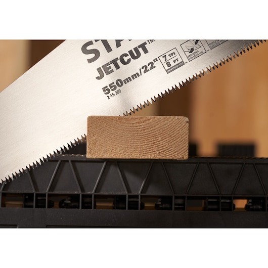 STANLEY 2-15-289 hand saw close-up cutting wood, photography, angled view on teeth and blade.
