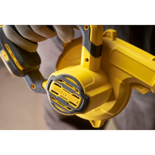 STANLEY SFMCBL01B yellow and black cordless blower close-up in use, visible branding on ventilated casing.