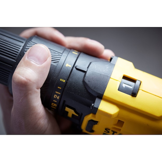 STANLEY SFMCD711B cordless drill close-up showing yellow and black body with speed setting.