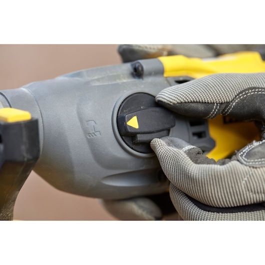STANLEY SFMCH900B rotary hammer control dial close-up with gloved hand, photography.