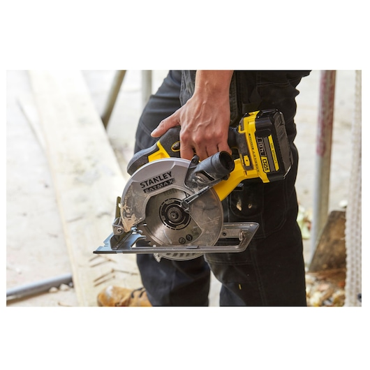 Photo of STANLEY SFMCS500M1K cordless circular saw held by a person, showing blade and handle details.